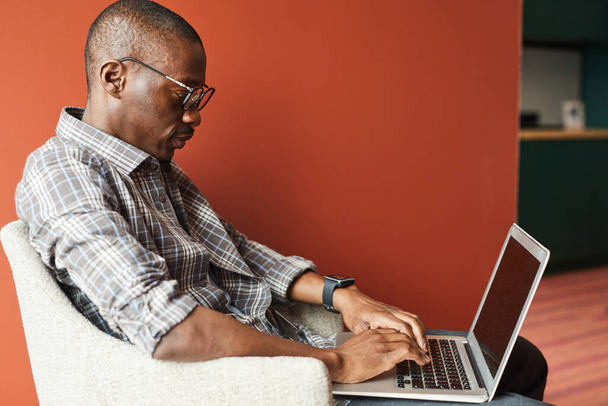 African businessman typing on laptop - Photo, Image