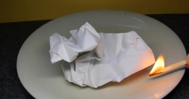 A match lights a ball of paper and it burns brightly - Footage, Video