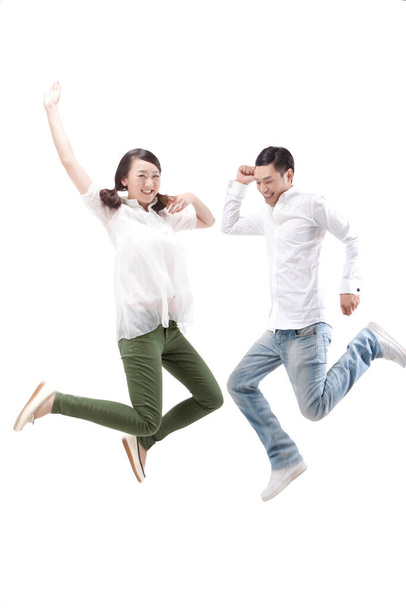Oriental fashion young couple jumping - Foto, afbeelding