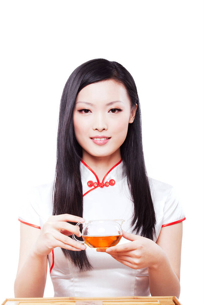 	Wearing cheongsam Oriental young woman in the preparation of tea	 - Photo, Image