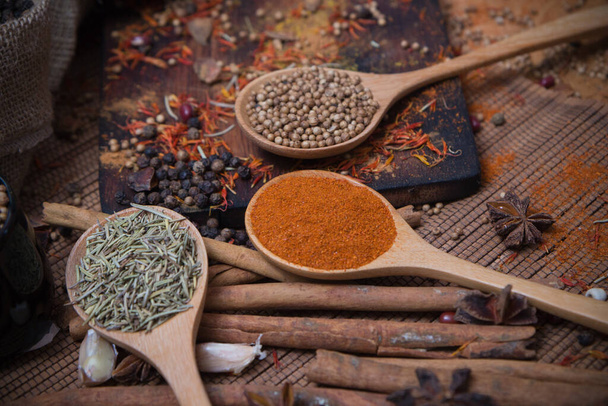 Spicy condiment, herbal aroma dry food for Asian cooking on wood  cutter with dry seed and colorful powder for kitchen ingredient - Foto, Imagem