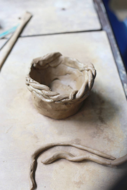 Ceramic molding, pottery dough making using wet soil and heated dough with high hot temperature. Molding and create pot is an 3D art - Zdjęcie, obraz