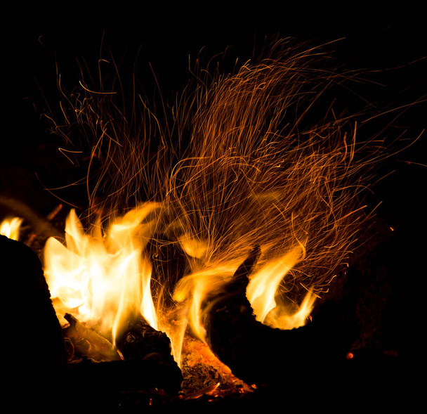 fire with sparks on a black background . - Photo, Image