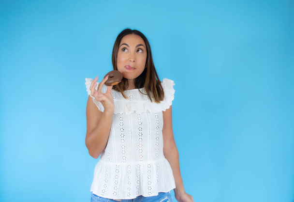 Femme en chemise blanche avec un morceau de chocolat - Photo, image