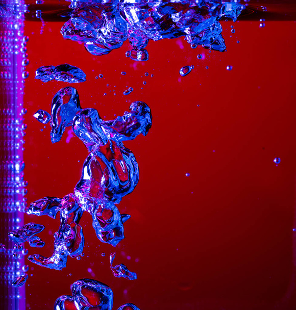 Close up view of the cold and fresh cola with bright bubbles in neon light - Fotografie, Obrázek