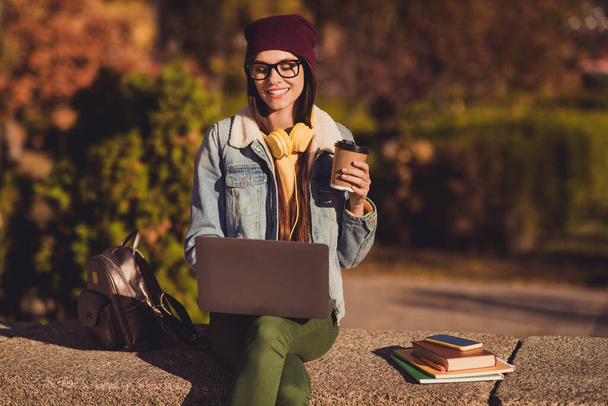 Portrait of her she nice attractive pretty cheerful skilled girl specialist expert using laptop profession preparing report homework presentation drinking latte outdoor outside fresh air nature - Foto, imagen