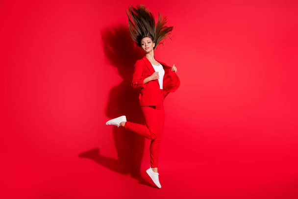 Full length profile photo of attractive worker lady jumping high up hairstyle flight look side empty space wear blazer suit trousers footwear isolated bright vivid red color background - Foto, Imagem