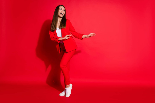 Full length photo of attractive funny lady successful worker having fun dance party colleagues event meeting good mood wear blazer suit pants shoes isolated red color background - Fotó, kép