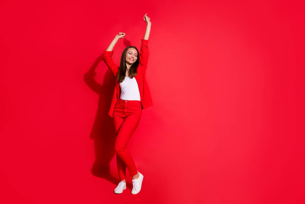 Full body photo of attractive funny business lady success worker having fun corporate party colleagues event meeting wear blazer suit pants shoes isolated red color background - Фото, зображення