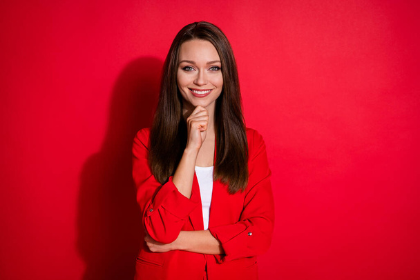 Photo of confident pretty business lady manager hold arm on chin toothy beaming smiling good mood wear office blazer suit white shirt isolated bright red color background - Фото, зображення