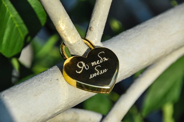 Wedding hinged lock lovers hanging on the fence of the bridge as a symbol of eternal love - Photo, Image