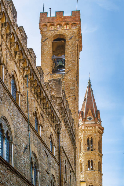 Bell tower of the Badia Fiorentina and Bargello Palace in Florence, Italy - 写真・画像