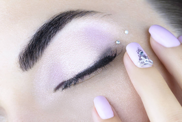 Light pink makeup and a light pink manicure with lace and rhinestones.Beautiful makeup and manicure. Close up - Photo, Image