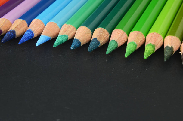 color pencil on dark background, color pencils, back to school material, back to school, colorful pencils lines up, rainbow style - Photo, Image