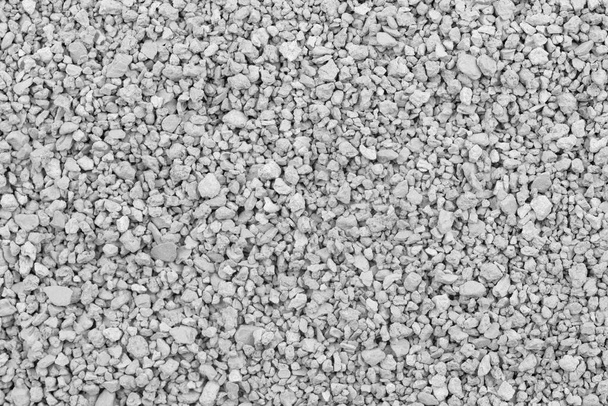 Gray small rocks ground texture. black small road stone background. gravel pebbles stone seamless texture. dark background of crushed granite gravel, close up. clumping clay - Photo, Image