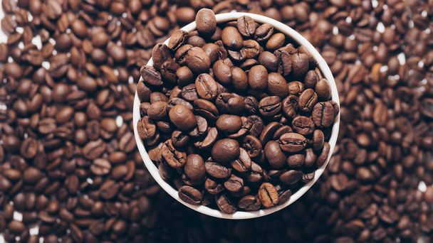 Fragrant roasted coffee beans in a plastic cup inside,top view,close-up - 写真・画像