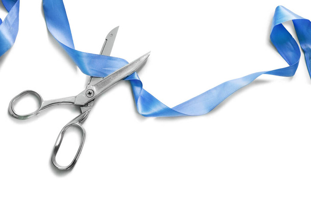 Scissors cut blue silk ribbon on white background - Fotografie, Obrázek