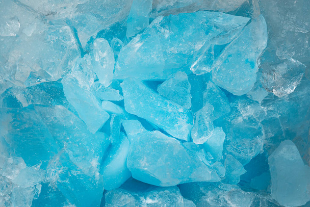 Kawałki zgniecionego niebieskiego szkła lodowego pęka tekstury tła. Zamrożona woda z bliska - Zdjęcie, obraz
