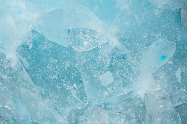 Pieces of crushed blue ice glass cracks background texture. close-up frozen water - Photo, Image