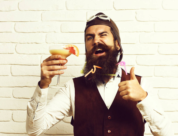 funny handsome bearded pilot on white brick wall background - Foto, imagen