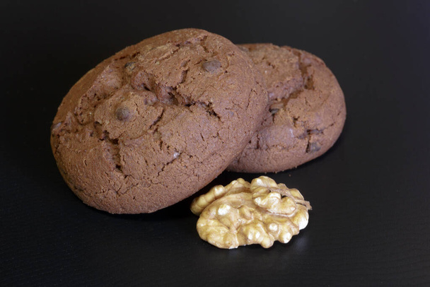 Chocolate cookies. Chocolate pieces on dark background. - Photo, Image