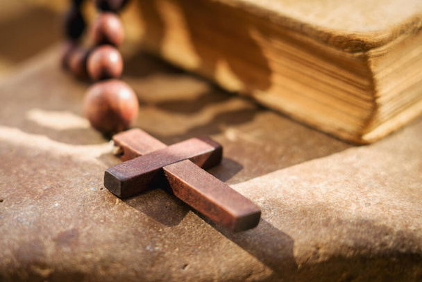 Χριστιανισμός, θρησκεία, πίστη. Ροζάριο σταυρό σε φόντο Αγία Γραφή ως σύμβολο της νίκης επί του θανάτου. - Φωτογραφία, εικόνα