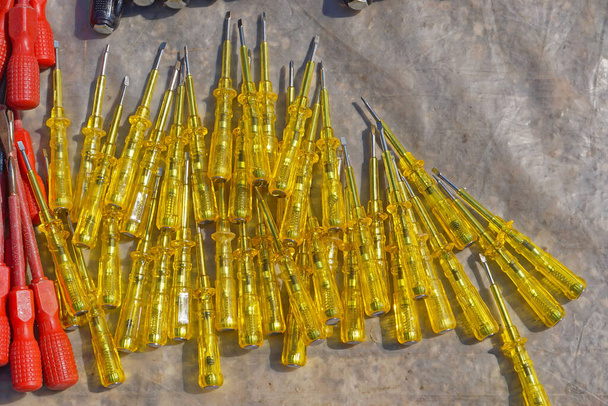 Big bunch of yellow tester voltage screwdrivers - Photo, Image