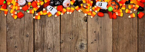 Halloween candy long border banner. Top view on a rustic wood background with copy space. - Photo, Image