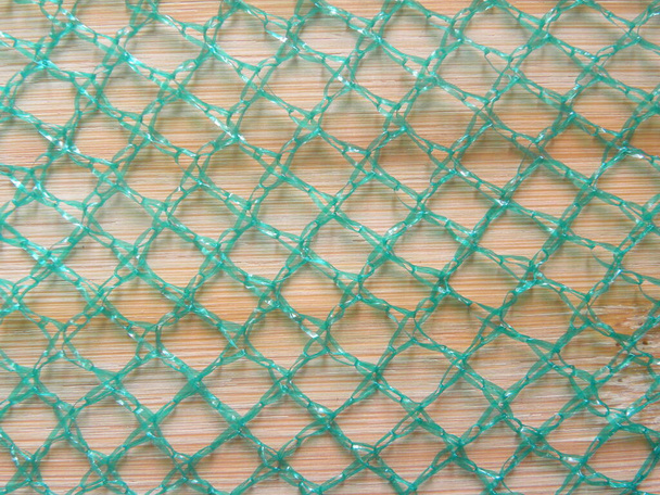 Zöld színű net táska texturált háttér - Fotó, kép