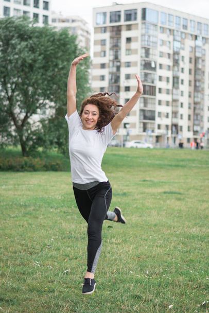 Young woman stretching body after jogging - Fotó, kép