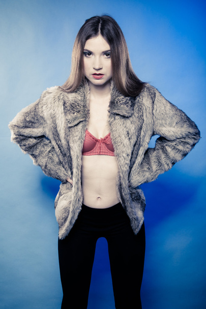 Sexy girl with long hair in red bra underwear and fur coat on blue - Φωτογραφία, εικόνα