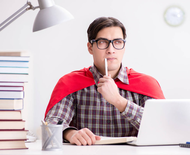 Super hero student with a laptop studying preparing for exams - Foto, Imagen