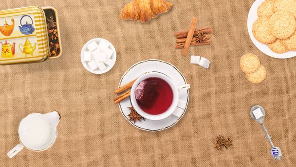 トップビューは、クッキー、砂糖、牛乳、ハーブやお茶のカップでお茶サービスを提供しています。お茶に関連する背景やバナー。朝食とオーガニックフードのコンセプト。茶色の表の構成. - 写真・画像