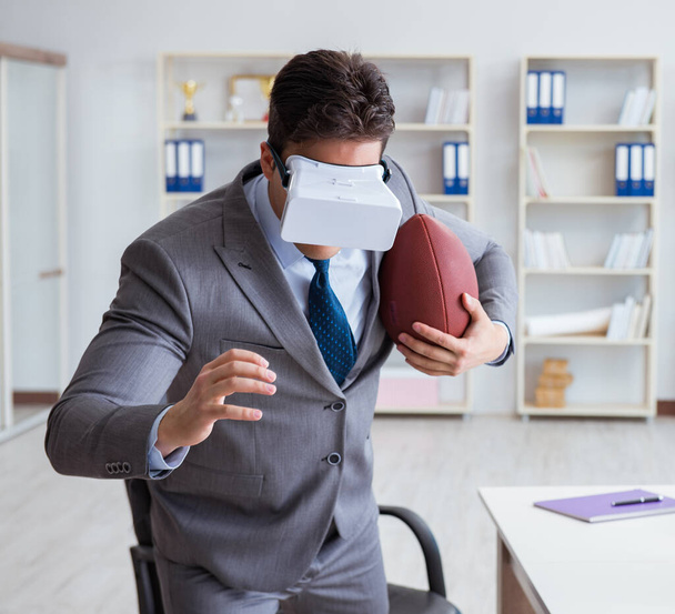 Businessman playing virtual reality football in office with VR g - Photo, Image