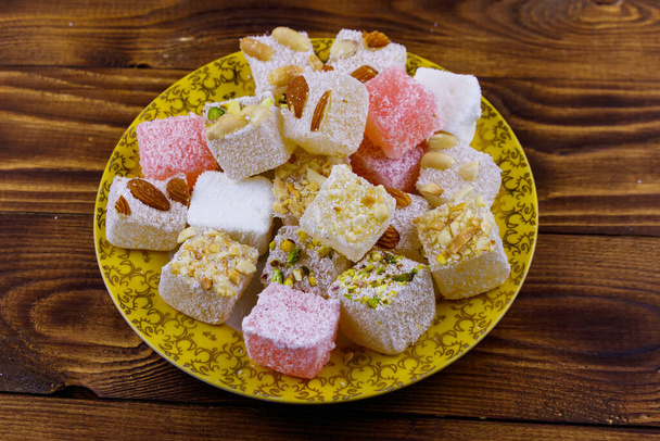 Turkish delight in a plate on wooden table - Photo, Image