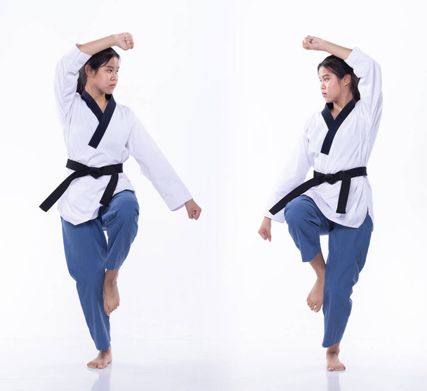 Master Black Belt TaeKwonDo Karate national athlete young teenager show traditional Fighting poses Poomse in sport dress, studio lighting white background isolated, motion blur on foots hands - Photo, Image