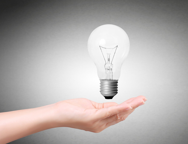 Ideas bulb light on hand - Photo, Image