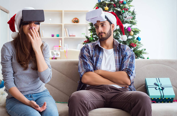 Happy family using virtual reality VR glasses during christmas - Photo, Image