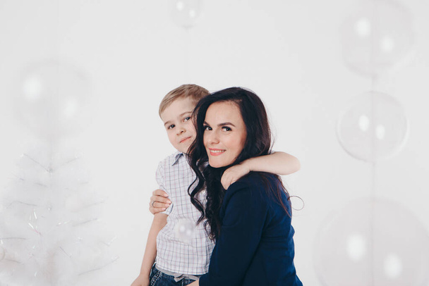 family at the Christmas tree. woman and child isolated on a white background. new year celebration. - Foto, immagini