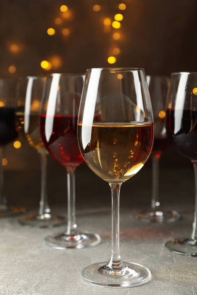 Glasses of wine against background with blurred lights - Fotó, kép