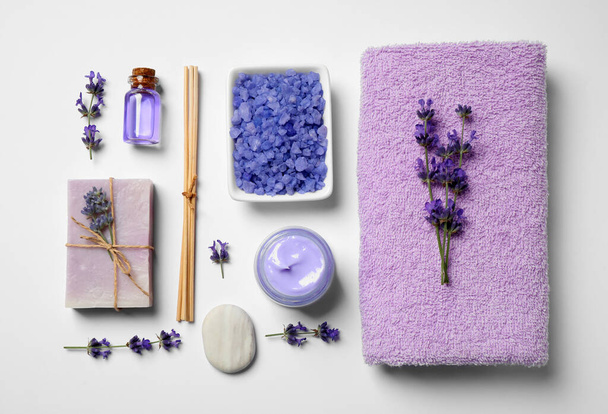 Cosmetic products and lavender flowers on white background, flat lay - Photo, image