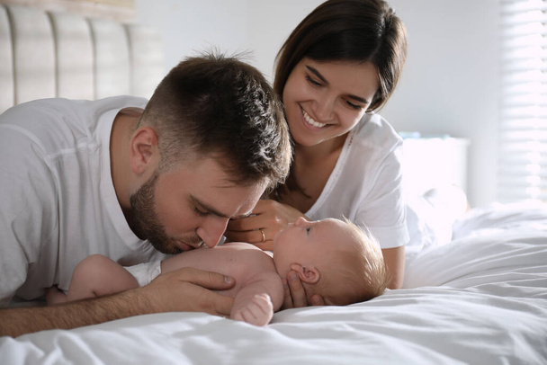 Happy couple with their newborn baby at home - 写真・画像
