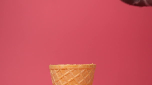  Ice cream Cookies & Cream scoop in waffle cone on pink background - Footage, Video