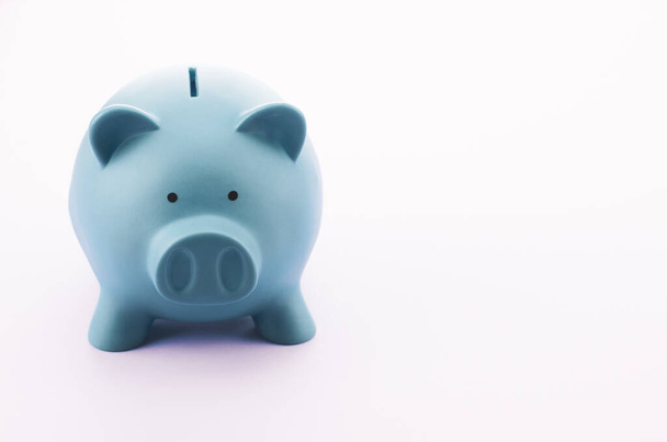 A closeup shot of a piggy bank on a white surface - investments and savings concept - 写真・画像
