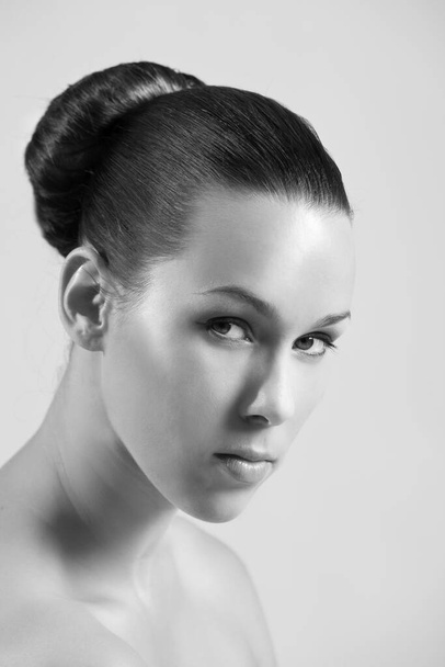 black white photo, Beautiful brunette woman model posing in studio, hair bun hairstyle  - Photo, Image