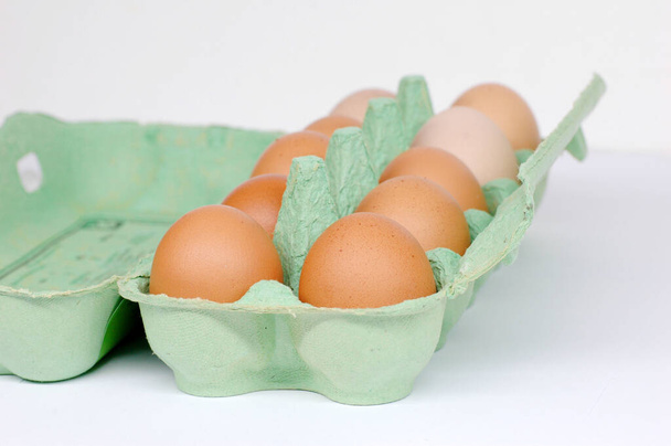 A light green box of chicken eggs on white background - Φωτογραφία, εικόνα