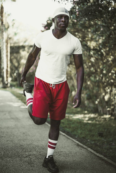 A shallow focus shot of a young black male jogging in a park - Φωτογραφία, εικόνα