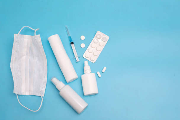 Nasal spray, pills, syringe, bandage injection on a blue background. Medicine concept. Mockup. - Fotoğraf, Görsel