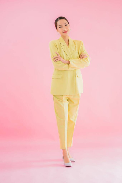Portrait beautiful young asian business woman smile in action on pink color background - Foto, Imagem