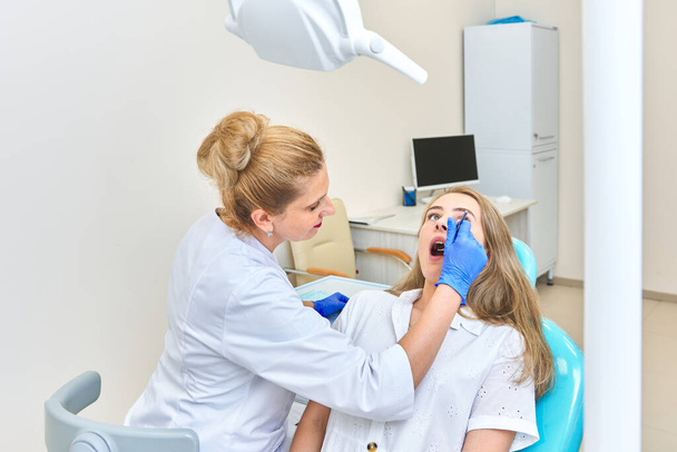examination of the teeth and mouth of the girl at the dentist. dentist appointment - Фото, изображение